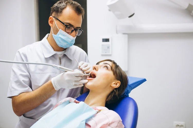 family dentist checking a woman patient