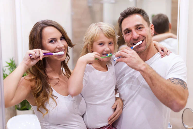 family doing toothbrush together and maintaining their oral health 