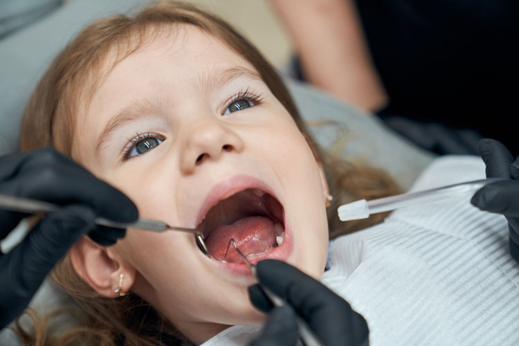 dentist examining a little kid
