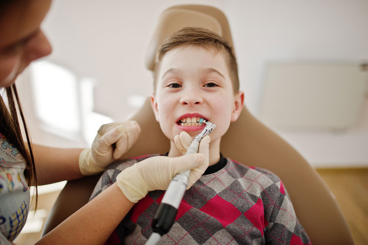 boy having dental check up done